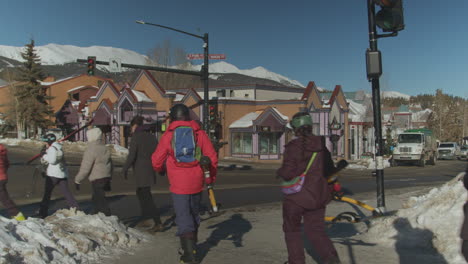 view of locals crossing the road surrounded by snow wearing cold gears in the western state of utah, united states on a winter morning.