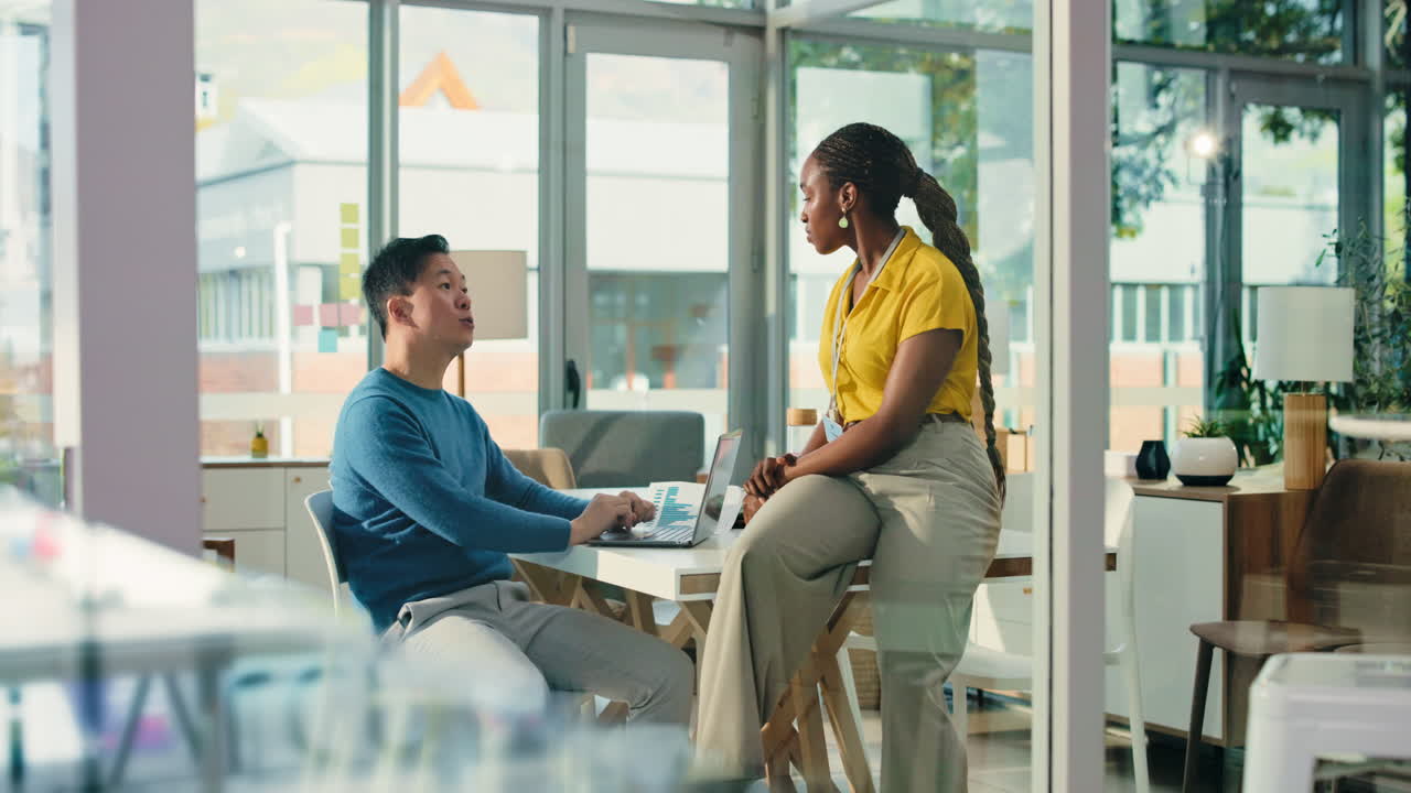 Diverse Business Colleagues Discussing Project on Laptop in Modern Office