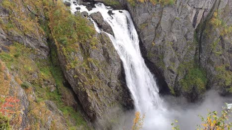 view along the impressive waterfall of voringfoss reaching into the depths