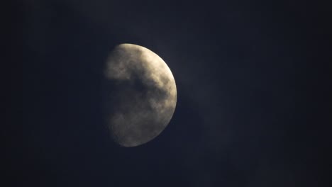 moon at night with cloud real time. 4k video moon in the black sky.  clouds passing by moon at night. night sky with cloudy weather