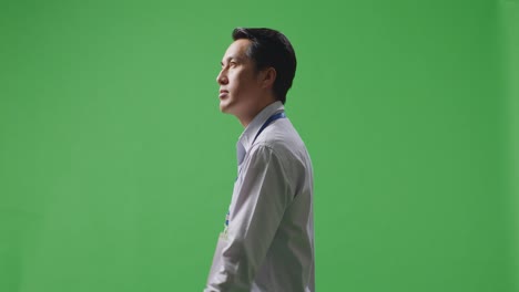 man in profile view against green screen