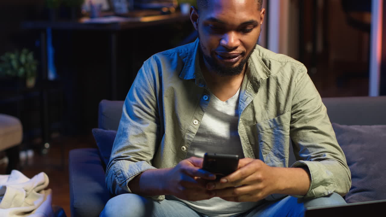 Vertical Video Carefree freelancer chatting with friends over text messages on phone