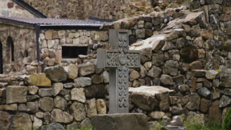 Ornate-carved-stone-cross-in-stone-ruins-of-Mtsvane-monastery,-Georgia