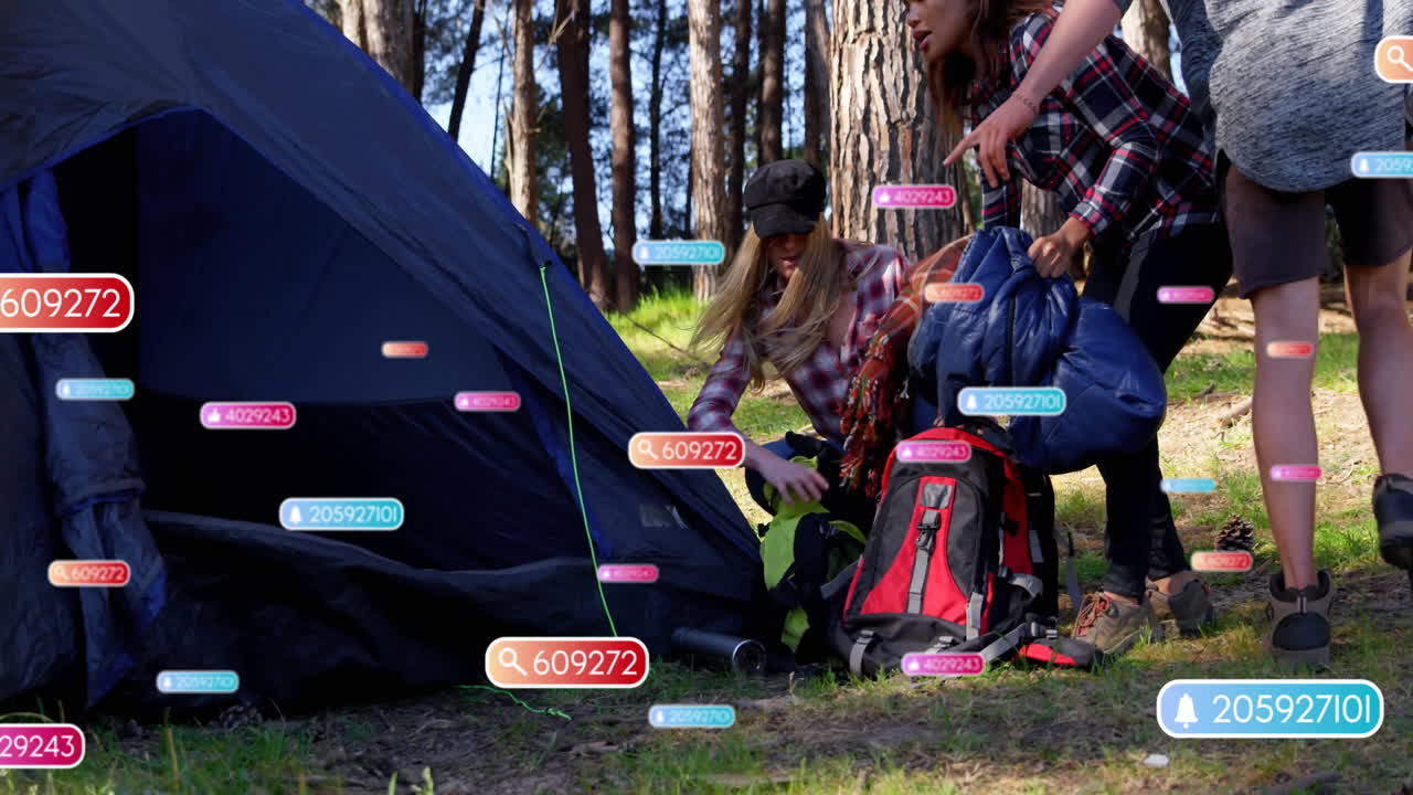Setting up camping gear in forest, people using animation with data tags overlay