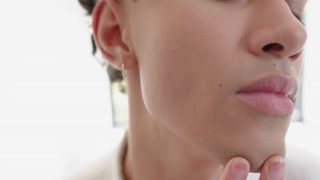 examining smooth skin, person touching face with fingers in close-up view
