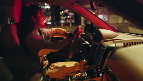 woman driving car at night