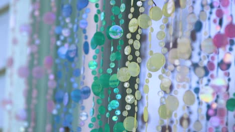 closeup of a colorful circular garland draped over a window