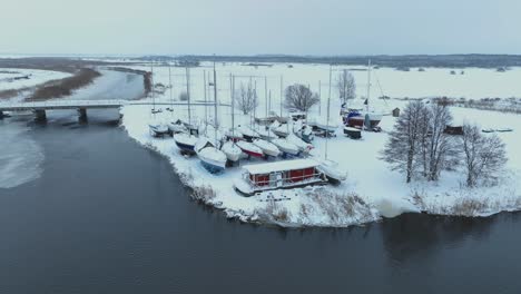 in winter, the yachts stand on the shore and are covered with a thick layer of snow