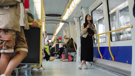 woman using phone on public transportation