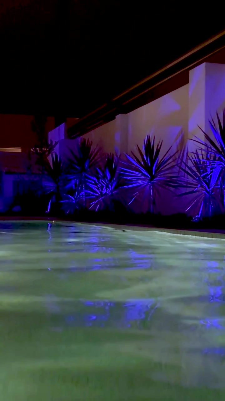Colorful lights reflecting on a serene pool