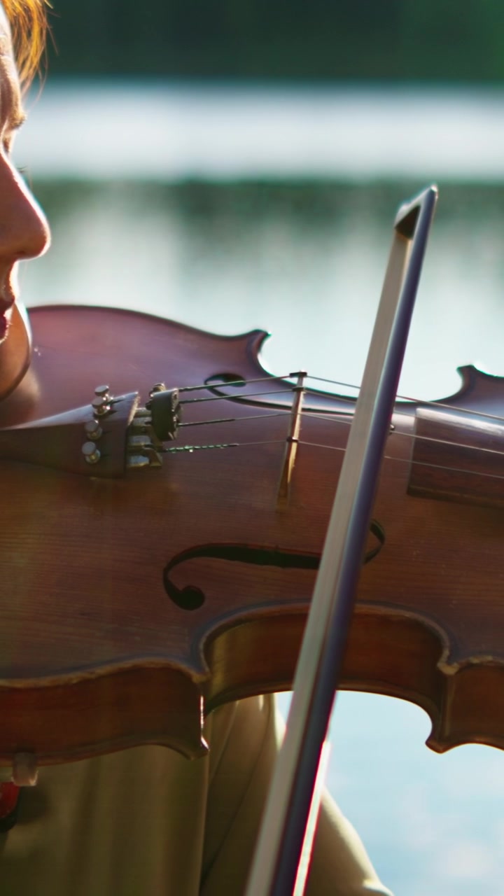 Close-up of a Woman Playing the Violin Outdoors