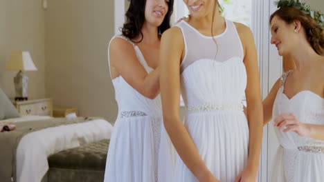 Happy-bridesmaids-wearing-head-wreath-and-getting-bride-ready-4K-4k