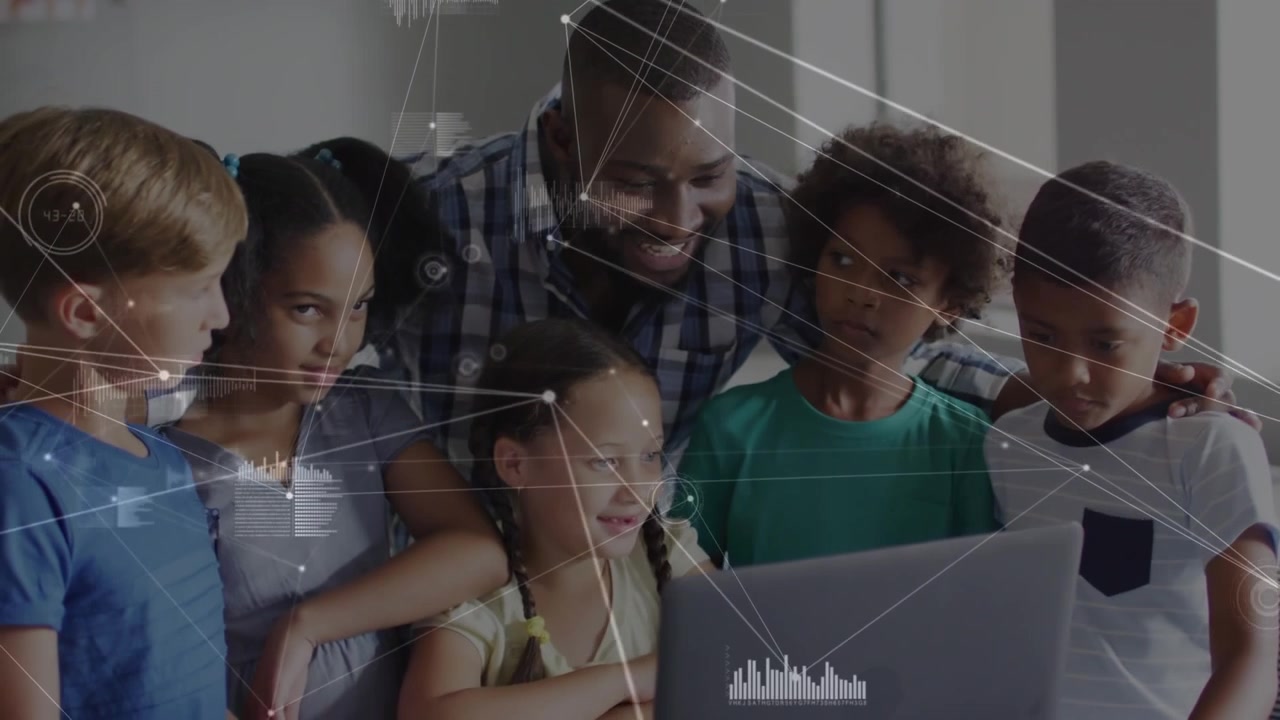 Teacher and Diverse Group of Students Using Laptop in Classroom