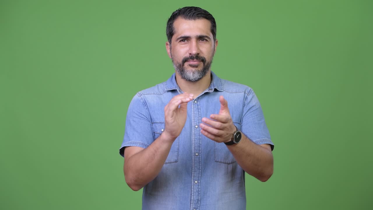 Handsome Persian bearded man clapping hands