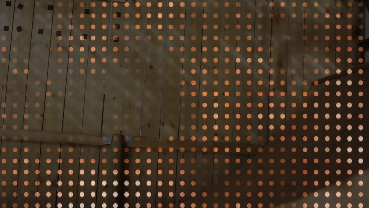 Wooden planks displaying dotted light grid, featuring horizontal beam and metal bracket support