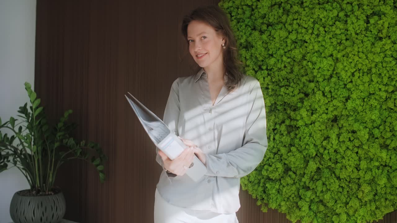 Woman Holding Documents in Modern Office