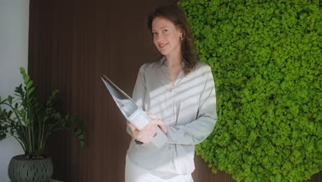 woman holding documents in modern office
