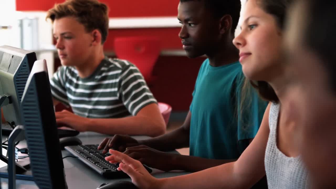Students studying on computer in classroom