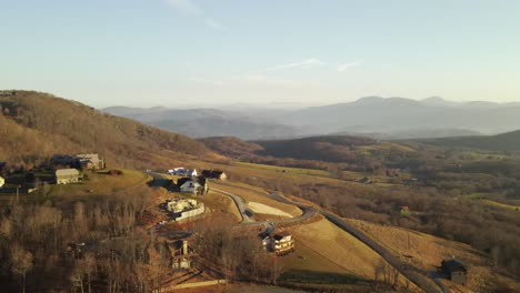 Little-hill-with-holiday-rental-houses-under-construction-on-a-side-of-a-hill-with-mountain-range-in-the-back-in-North-Carolina,-USA