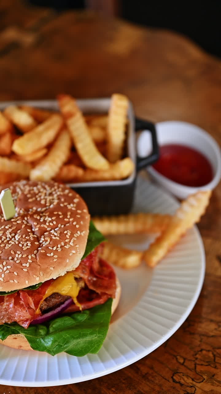 Classic cheeseburger with cola and fries on white plate. Fresh cheeseburger with cheese and ketchup served with french fries and cola drink on wooden table