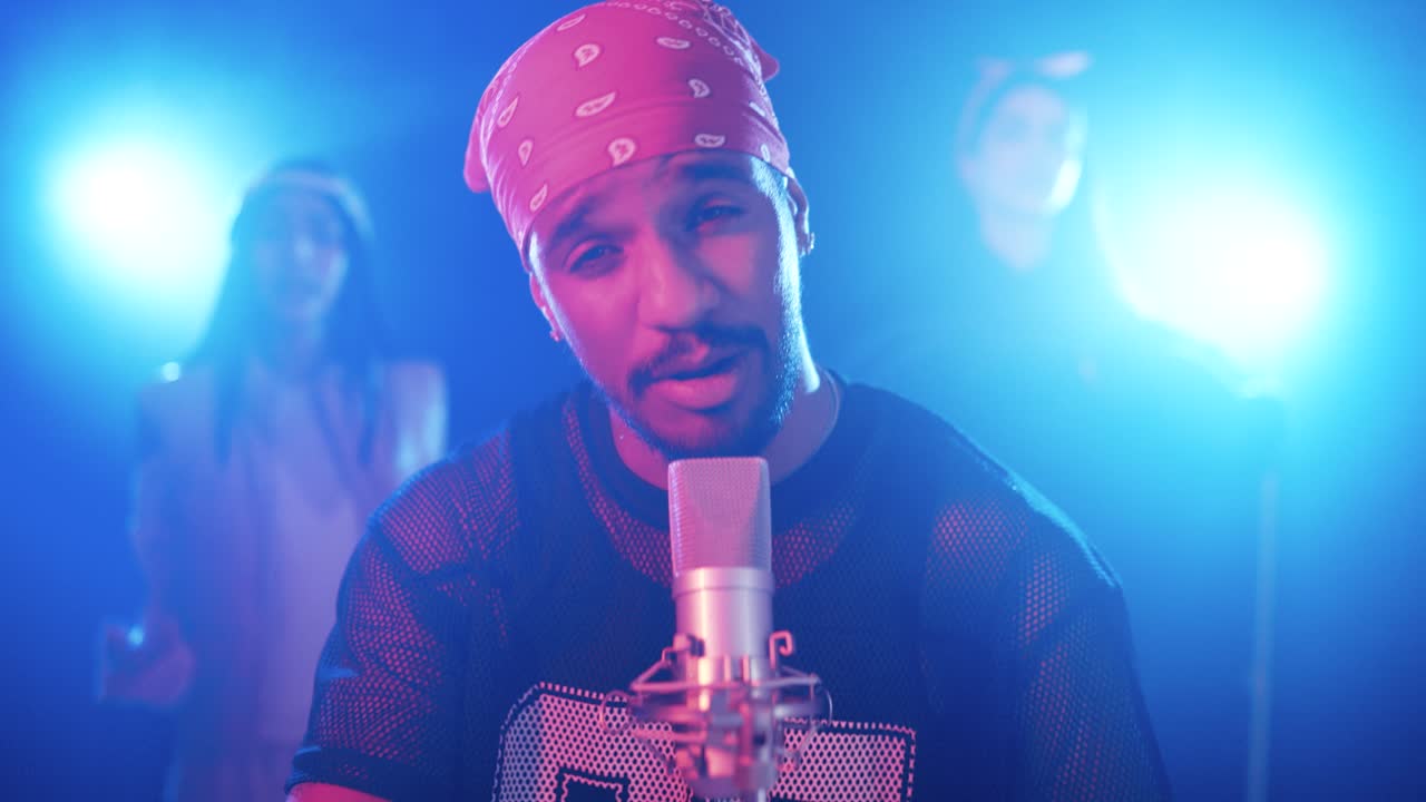 Reggaeton singer performing music with dancers in a music video