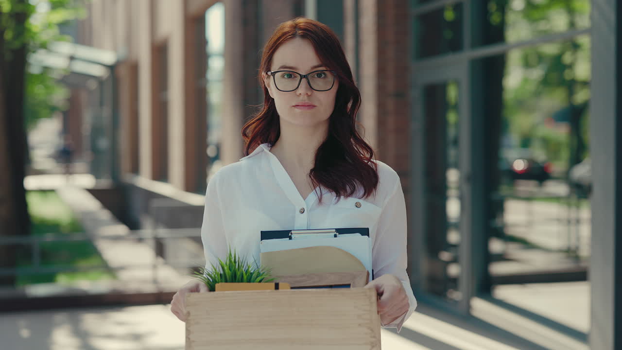 Woman Holding a Box of Belongings Leaving a Job