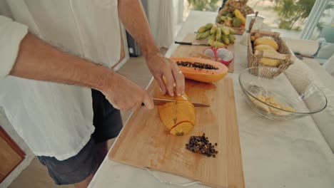 man cutting papaya