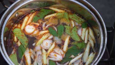 Looking-into-pot-of-Tom-Yam-soup-that-is-starting-to-boil