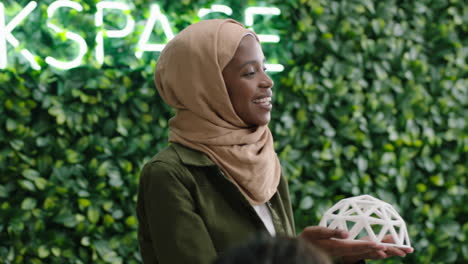 muslim business woman presenting geodesic dome model in office meeting colleagues brainstorming creative design solution discussing engineering ideas in startup presentation