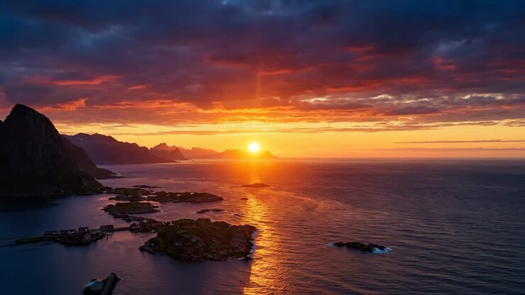 Aerial View of Vibrant Sunset Over Coastal Mountains and Fjord Village