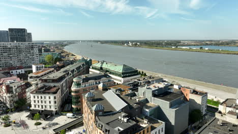 aerial view showing neighborhood in antwerp with modern blocks and schelde river during sunny day