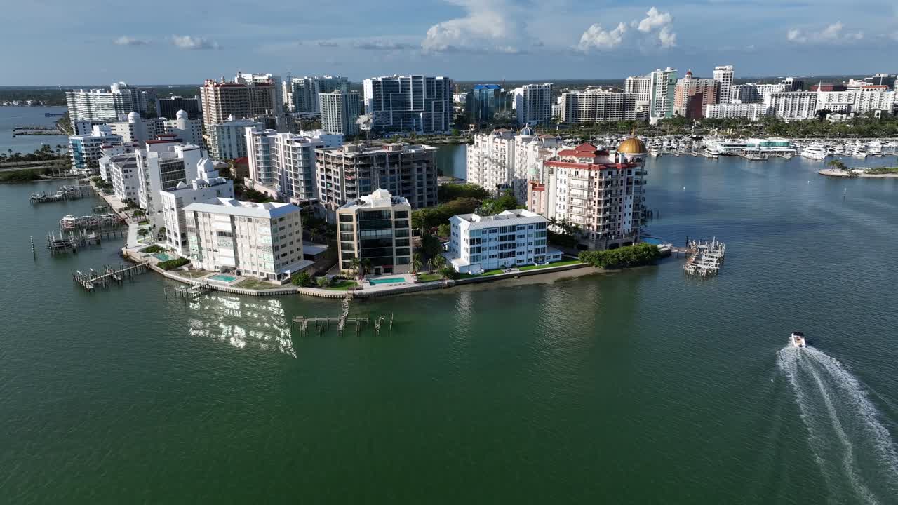 Luxury apartment hotels and resort with swimming pool in Sarasota, Florida. Sunset time with skyline in background. Aerial view.