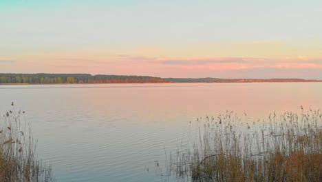 Pastel-color-sunset-over-the-lake-Michigan,-USA,-aerial-dolly-in