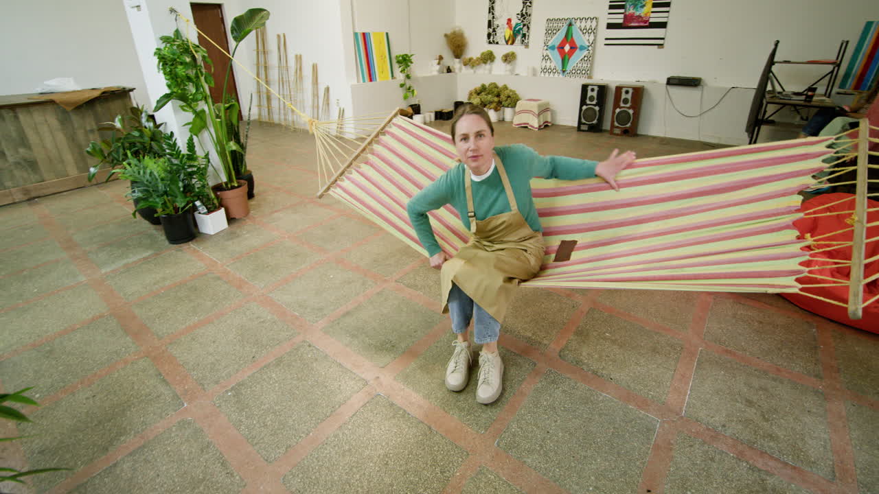 Woman Relaxing in a Hammock in an Artistic Studio