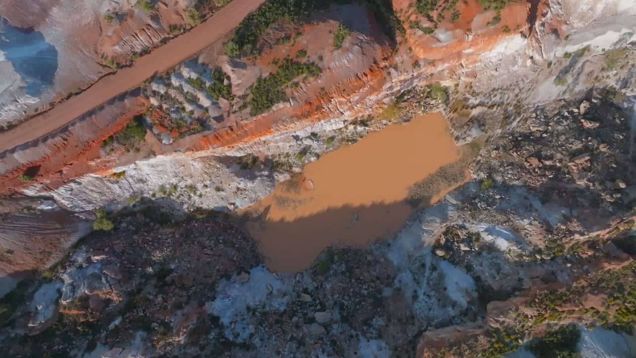 Circling above the devastated ground left by an old abandoned mine full of water