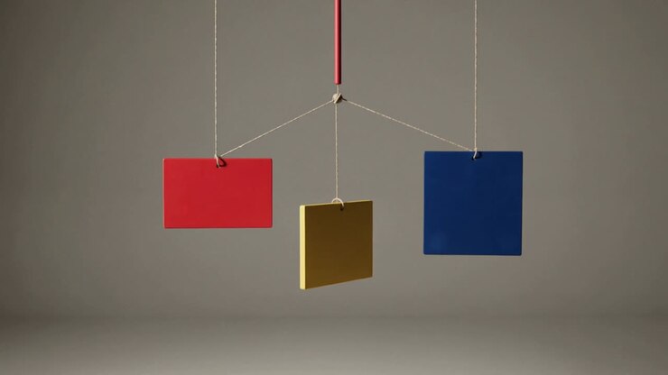 Swinging, nudged three-panel mobile rotating and settling into balance in set with red rod and hub