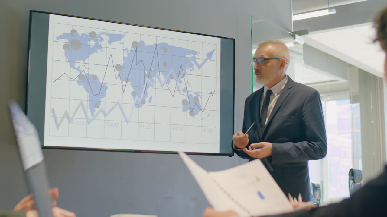 Senior Man Giving Presentation on Business Meeting