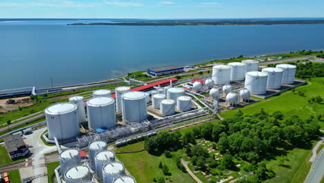 Aerial-view-away-from-a-large-oil-product-rehandling-terminal,-sunny,-summer-day