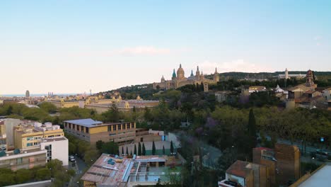 Sprawling-city-of-Barcelona-Spain-sits-below-Museu-Nacional-d'Art-de-Catalunya-looking-over-from-top-of-hillside