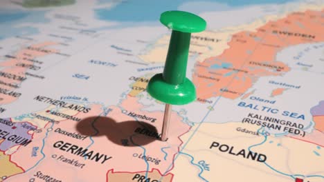 germany - travel concept with green pushpin on the world map. the location point on the map points to berlin, the capital of the german.