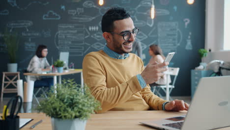 man using smartphone in modern office