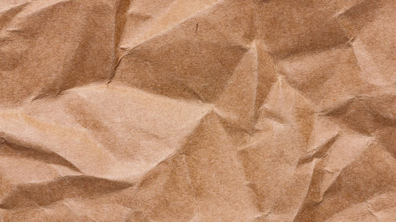 Stop motion loop of brown kraft wrapping sheet with pronounced creases