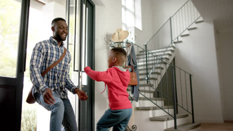 African-american-father-saying-hello-and-cuddling-with-son-after-work-at-home,-slow-motion