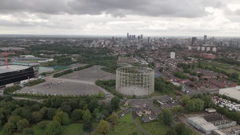 Aerial-over-Philips-Park-Cemetery-with-Manchester-panoramic-cityscape-view,-UK