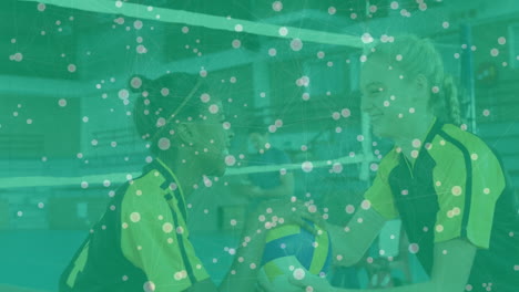 holding volleyball, two athletes with network connections animation overlay in gym