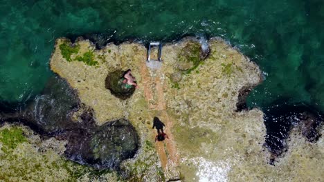 couple enjoying a natural pool by the sea in lebanon -top view