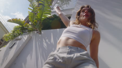 Woman Dancing Outdoors in Stylish Attire