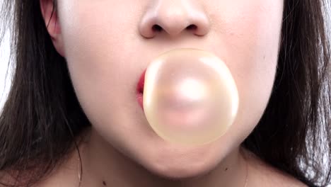 brunette girl blowing a bubble of yellow gum brunette blowing a bubble of gum yellow red lips face sexy