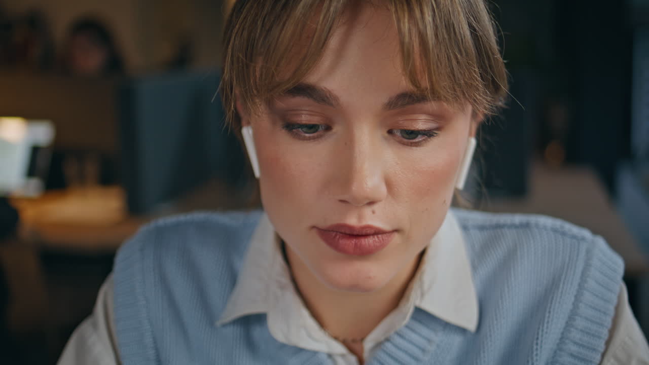 Lady designer calling earphones using laptop at office closeup. Woman talking