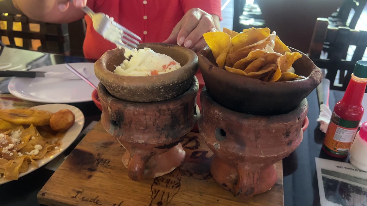 Honduras traditional anafre hondureño served in clay pots with tortillas and fresh sides, authentic local dining experience and Central American cuisine.